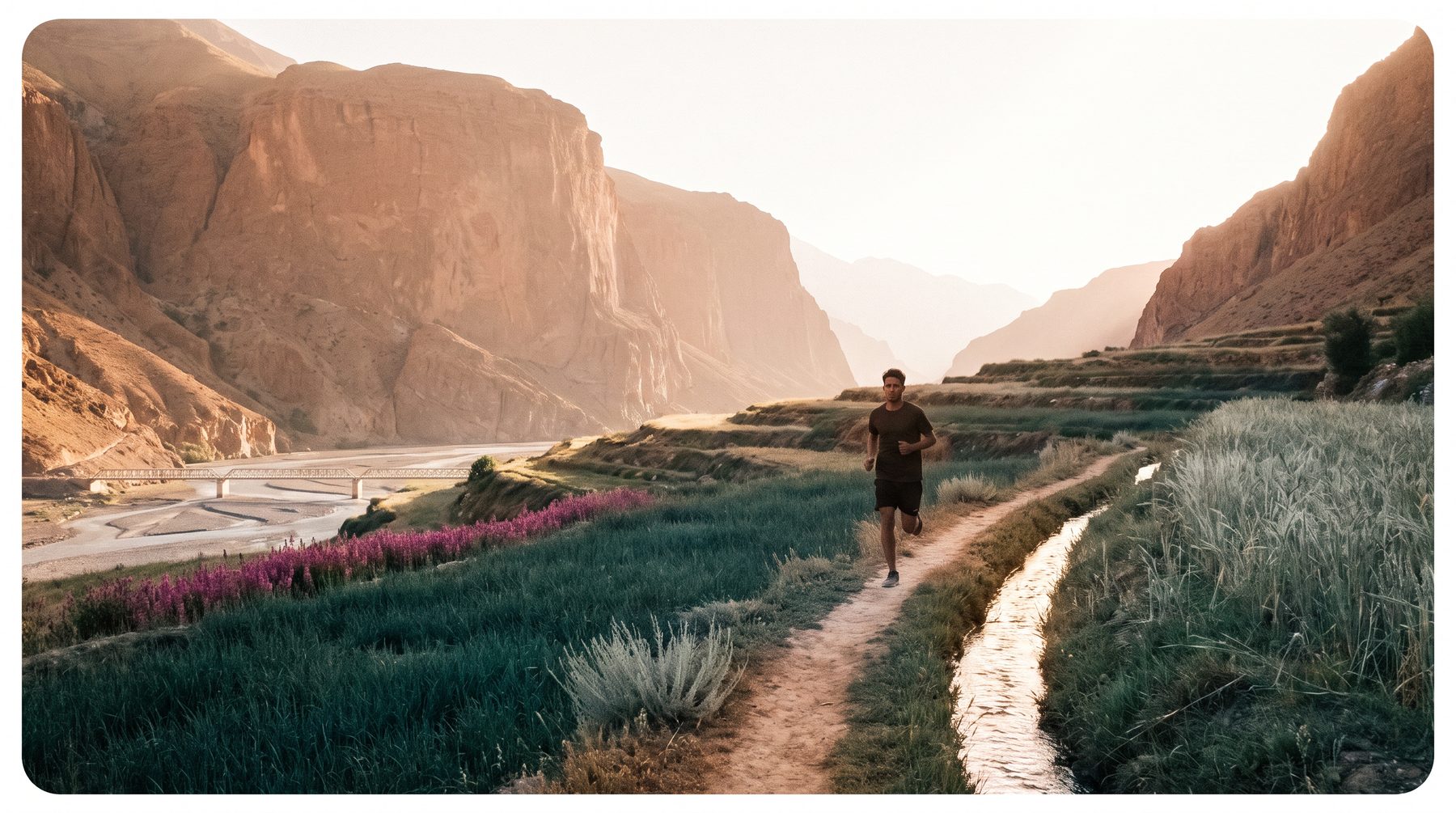 A single runner crossing a wide terraced valley floor